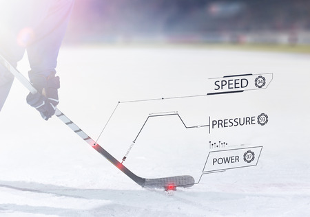 ice hockey player in action kicking with stickの写真素材