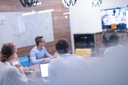 Group of a young business people discussing business plan at modern startup office buildingの写真素材