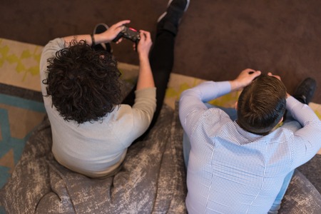 Work hard play hard. Workers Playing computer games in creative startup Officeの写真素材