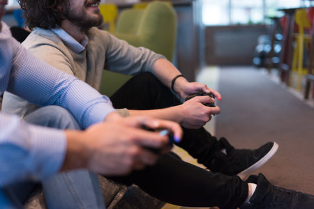 Work hard play hard. Workers Playing computer games in creative startup Office