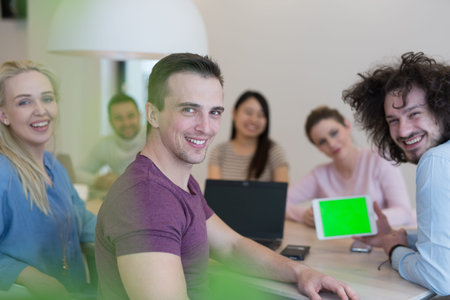 Group of a young business people discussing business plan at modern startup office building