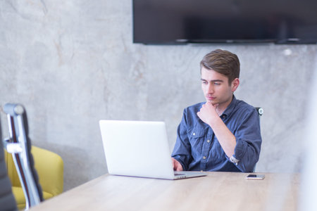 Young Entrepreneur Freelancer Working Using A Laptop In Coworking space