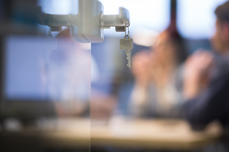 Open  glass door with keys, key in keyholeの写真素材