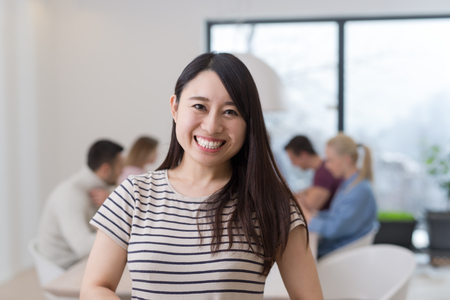Group of a young business people discussing business plan at modern startup office buildingの写真素材
