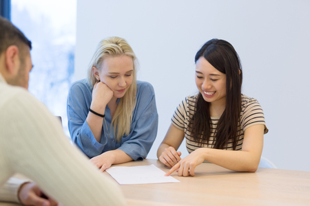 Group of a young business people discussing business plan at modern startup office buildingの写真素材