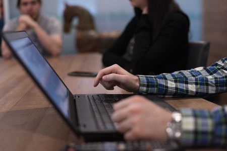 software developer writing programming code on laptop computerの写真素材