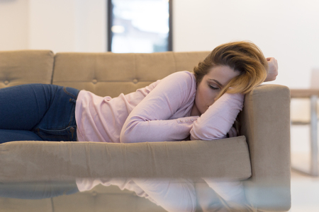 Beautiful Young Woman Sleeping On Sofa At Homeの写真素材