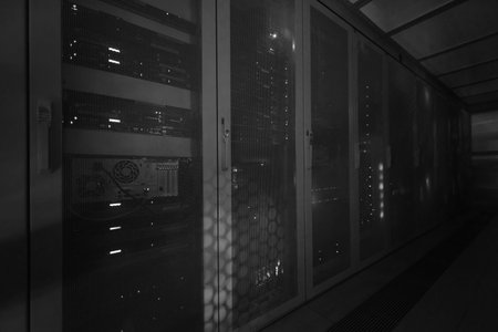 panel modern communication equipment with light from the display at data center in the server room