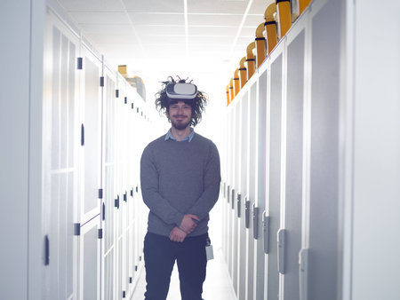 young IT engeneer using virtual reality headset over server room background