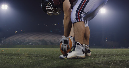 american football kicker ready for football kickoff closeup shot on the night fieldの写真素材