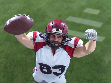 american football player celebrating touchdown isolated on stadium fieldの写真素材