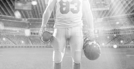 Closeup Portrait of a strong muscular American Football Player on big modern stadium field with lights and flaresの写真素材