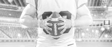 Closeup Portrait of a strong muscular American Football Player on big modern stadium field with lights and flaresの写真素材