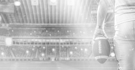 Closeup Portrait of a strong muscular American Football Player on big modern stadium field with lights and flaresの写真素材