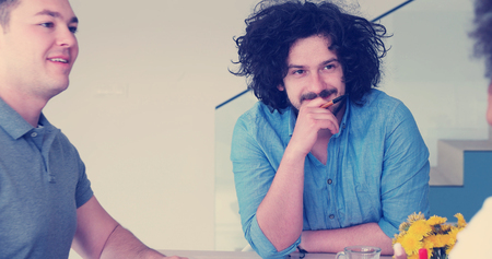 Group of a young business people discussing business plan at modern startup office buildingの写真素材