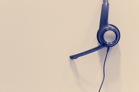 Headphones hanging on cubicle partition in empty call center officeの写真素材