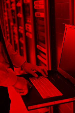 young handsome business man  engeneer in datacenter server room