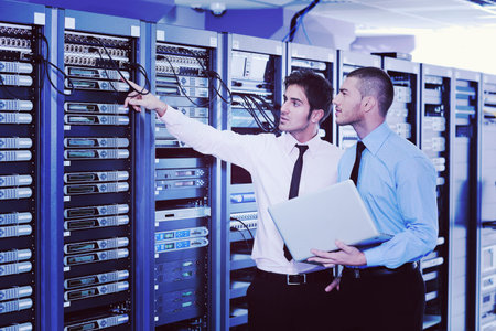 group of young business people it engineer in network server room solving problems and give help and...