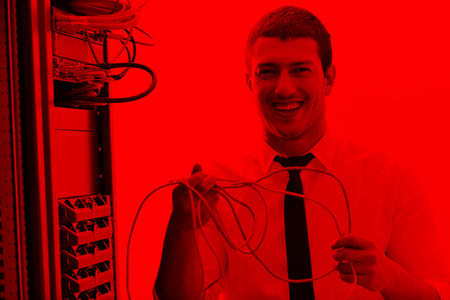 young handsome business man it  engeneer in datacenter server room