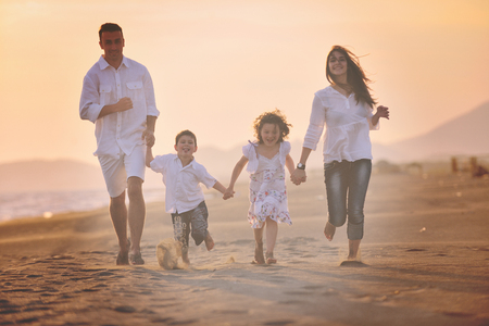 happy young family have fun and live healthy lifestyle on beachの写真素材