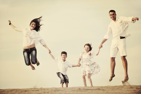 happy young family have fun and live healthy lifestyle on beachの写真素材
