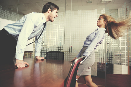 Angry business man screaming at employee in the officeの写真素材