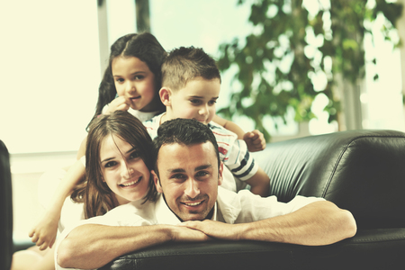happy young family relax and have fun at modern home indooorの写真素材