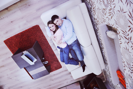 happy young couple relax at home in modern and bright living roomの写真素材