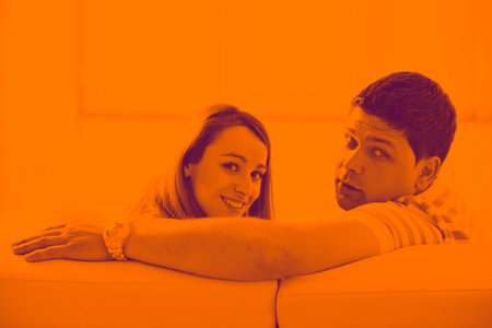 happy young couple relax at home in modern and bright living room duo toneの写真素材