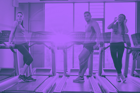 group of young people running on treadmills in modern sport  gym duo toneの写真素材