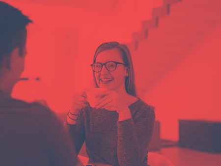 young beautiful handsome couple enjoying morning coffee and strawberries in their luxurious home villaの写真素材