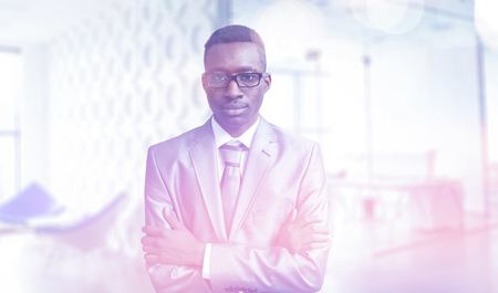 Portrait of young junior businessman in front of his big modern officeの写真素材