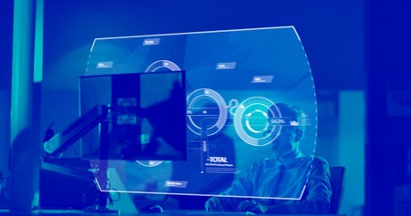 Young man working on computer at night in dark office. The designer works in the later time.の写真素材