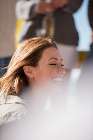Happy Group Of Friends Hanging Out At Beach House having fun and drinking beer on autumn dayの写真素材