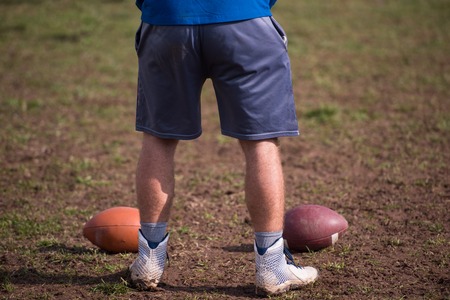 american football kicker practicing football kickoff closeup shotの写真素材