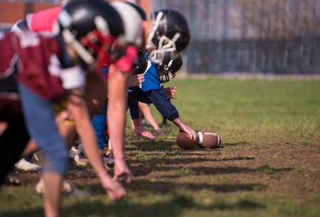 group of young american football players in action during the training at fieldの写真素材