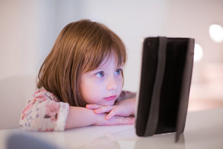 child playing with digital tablet at homeの写真素材