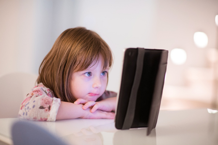 child playing with digital tablet at homeの写真素材