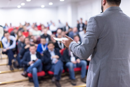 young businessman at business conference room with public giving presentations. Audience at the...