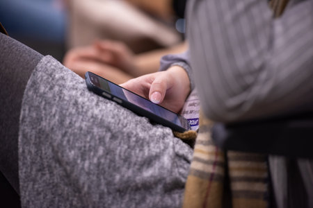 Business people hands typing on smart phone during the seminar at conference room