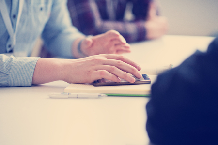 Young casual businessman using smartphone in the startup officeの写真素材