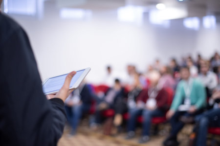 Young businessman at business conference room with public giving presentations