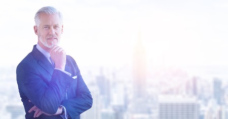 Portrait of senior businessman in front of big modern cityの写真素材
