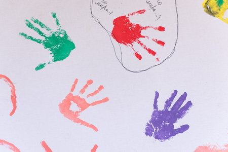 Child colorful hand prints on white