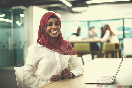 Young modern black muslim business woman wearing a red hijabの写真素材