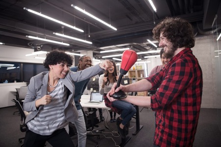 Multiethnics startup business team of software developers having fun while boxing at officeの写真素材