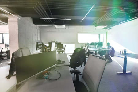 software developers working everyday job writing programming code at modern sunny bright open plan...