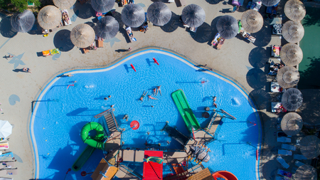 colorful water park aquapark water splash aerial top view of happy unidentified people and kids having fun and get relaxedのeditorial素材