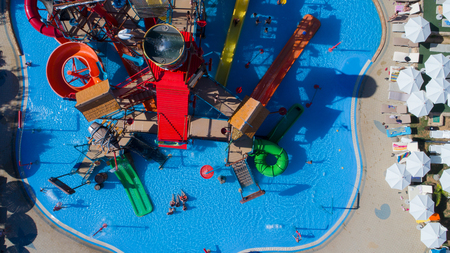 colorful water park aquapark water splash aerial top view of happy unidentified people and kids having fun and get relaxedのeditorial素材