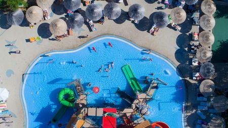 colorful water park aquapark water splash aerial top view of happy unidentified people and kids having fun and get relaxedのeditorial素材